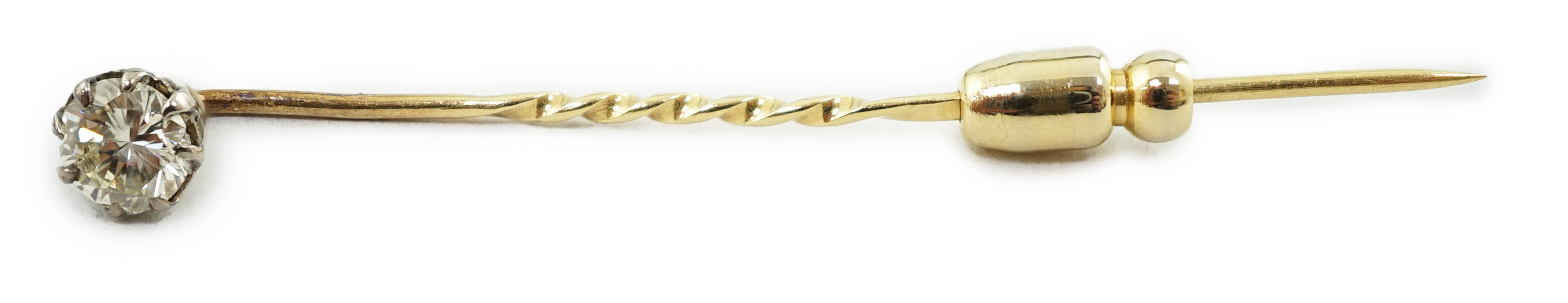 A late Victorian gold and solitaire diamond set stick pin